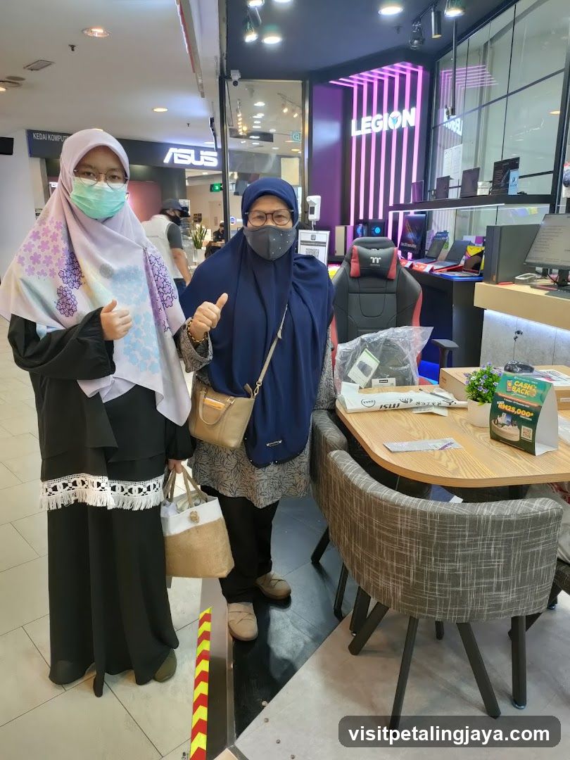 Two women posing in a tech store