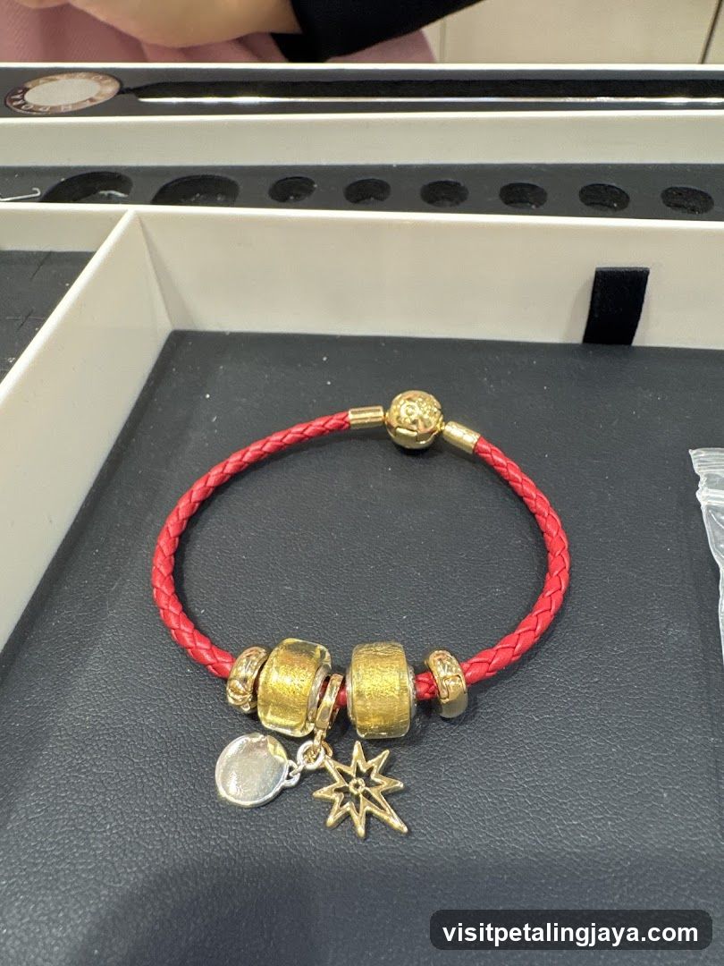 Red Braided Bracelet with Gold Beads and Charms