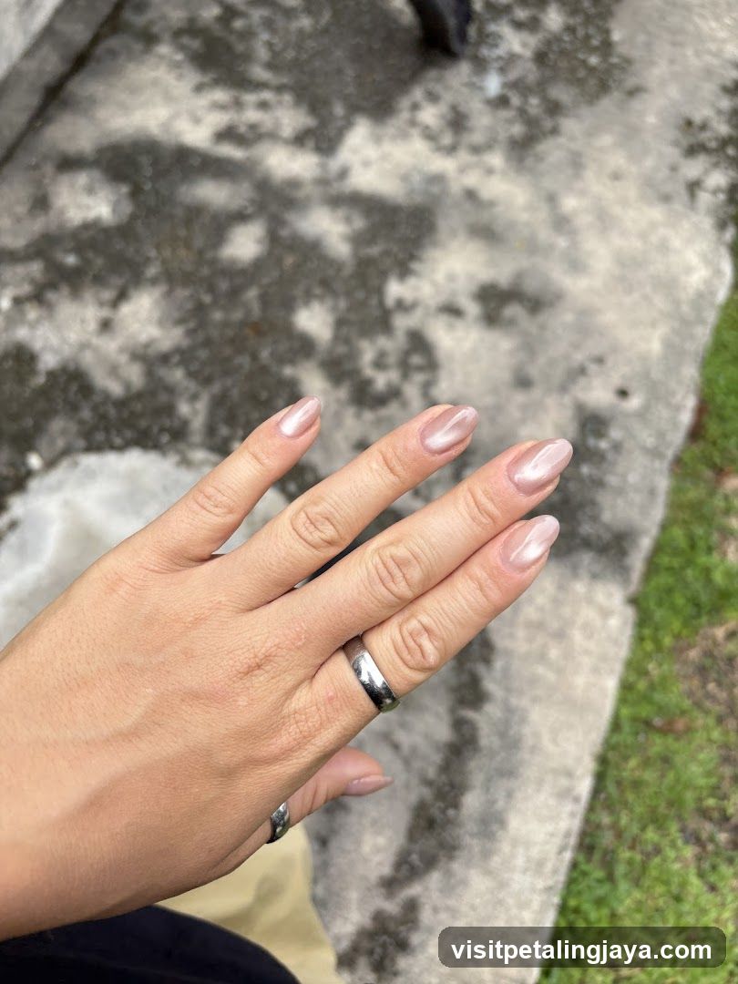 Hand with manicured nails and ring