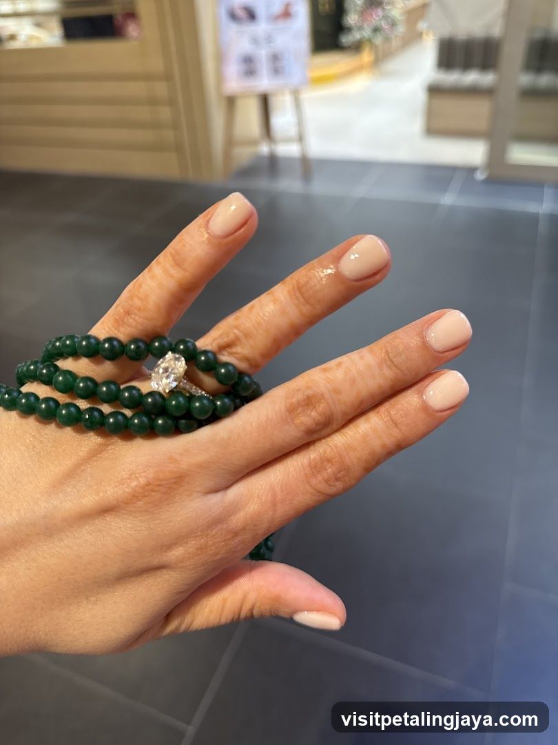 Hand with Green Beaded Bracelet and Ring