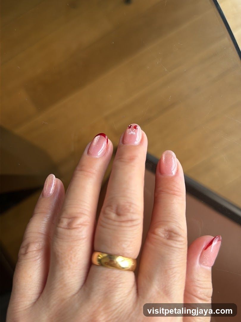 Hand with Pink Nail Art and Gold Ring