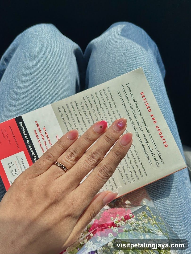 Hand holding a book and flowers