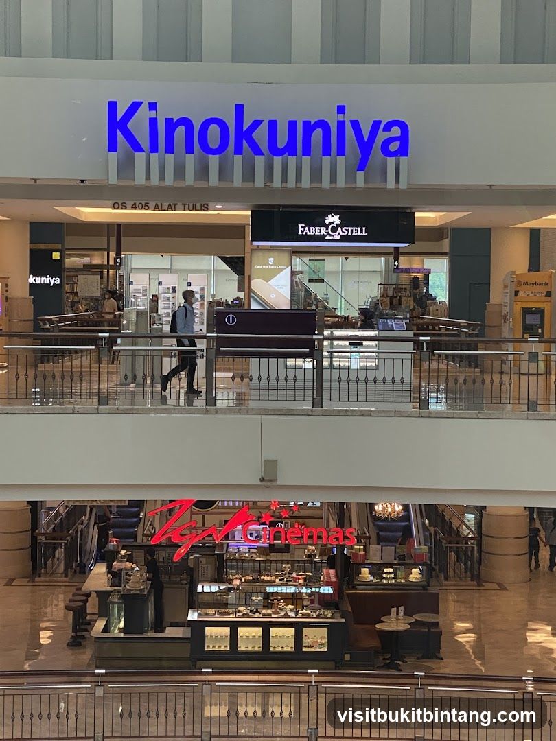 Interior of a shopping mall with stores and a cafe