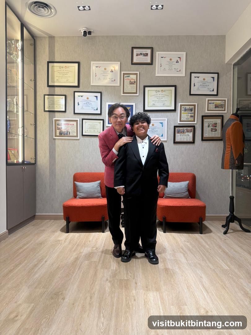Two people in formal wear posing in a room with framed certificates on the wall.