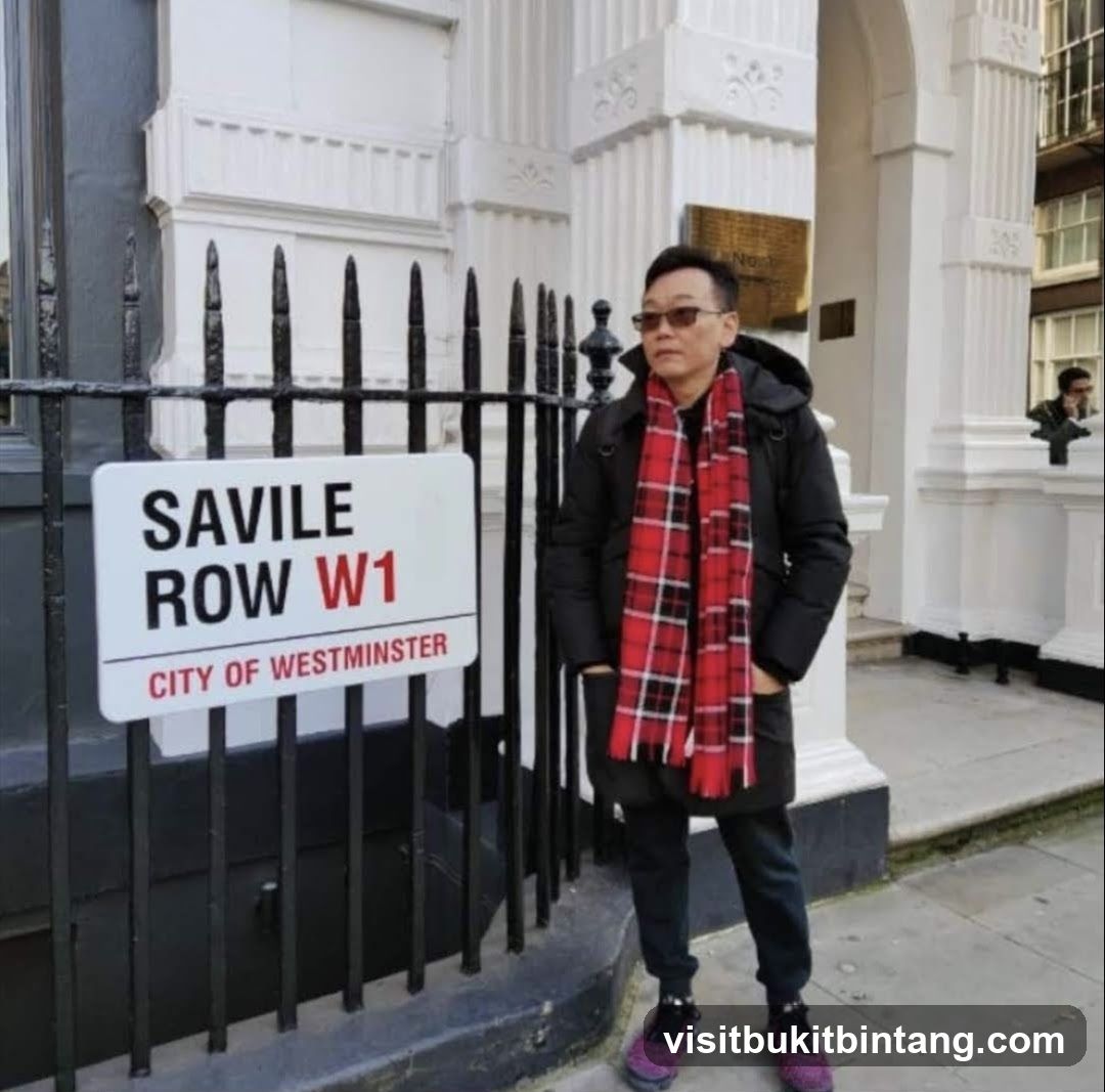 Man in front of Savile Row sign