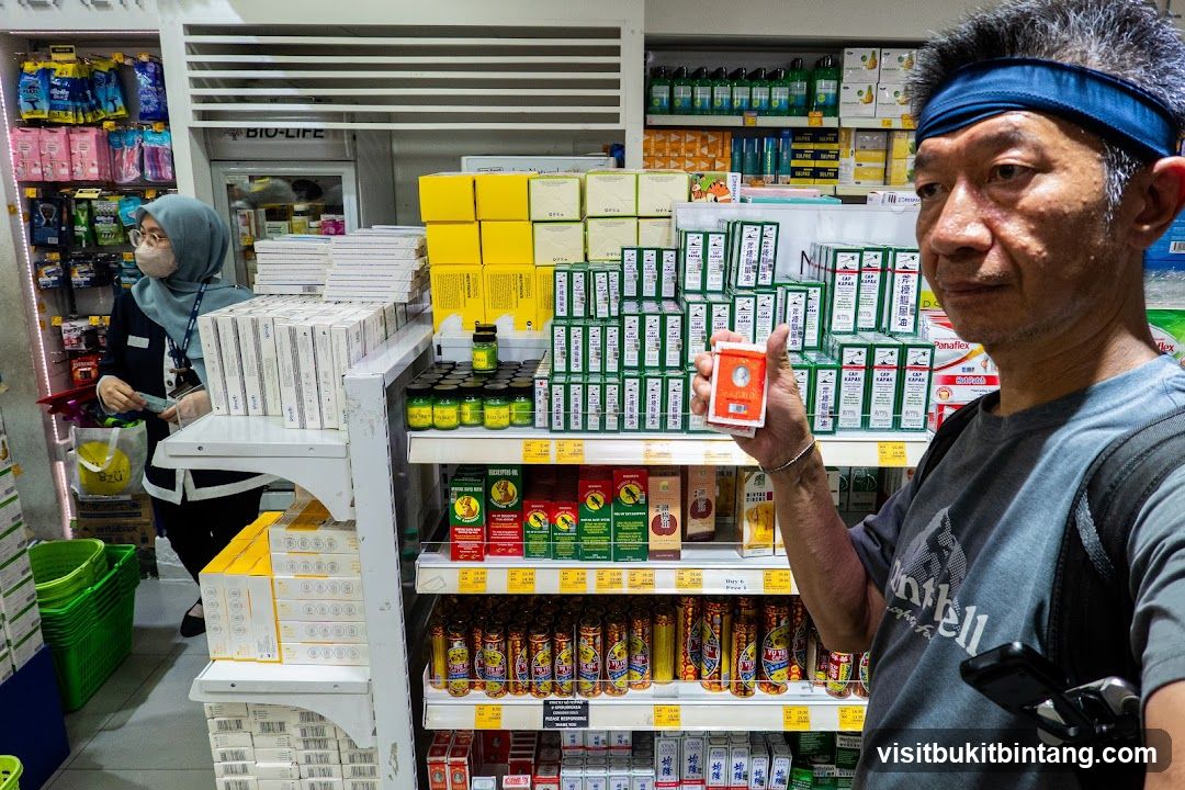Man holding a small box in a store