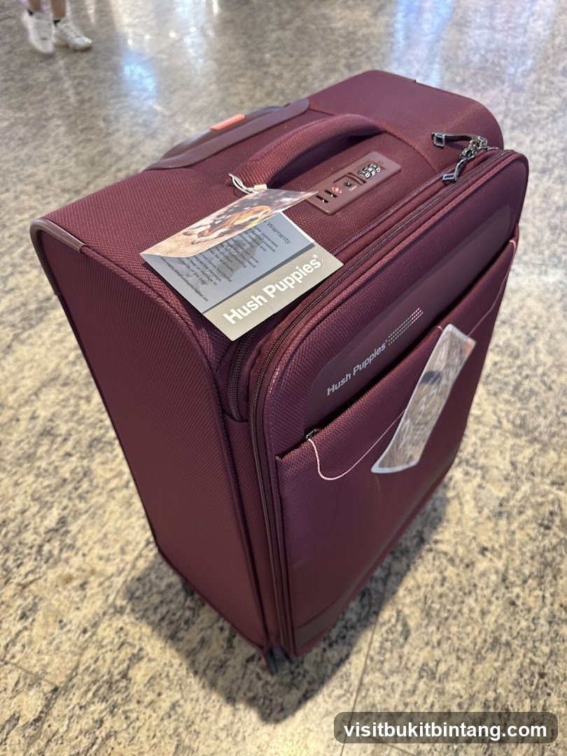 Maroon Suitcase with Hush Puppies Branding