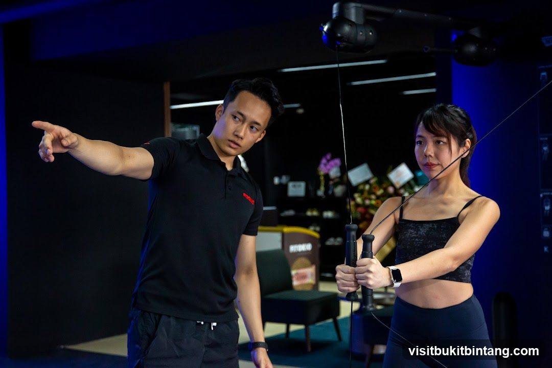 Fitness Instructor Assisting Client