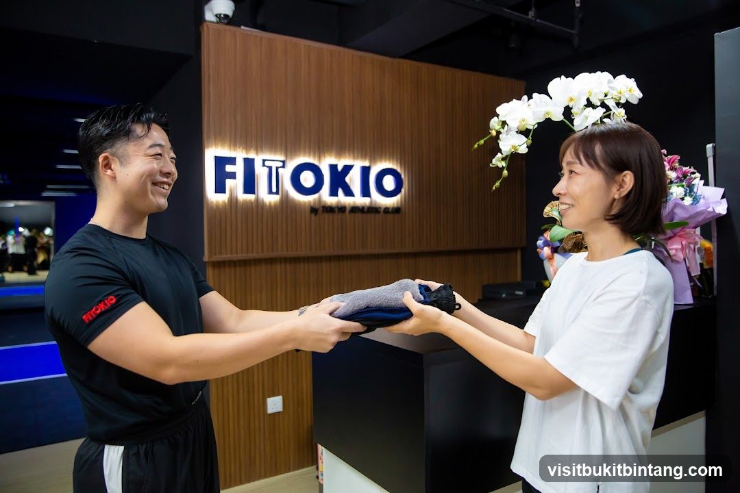 Gym staff handing over folded clothes