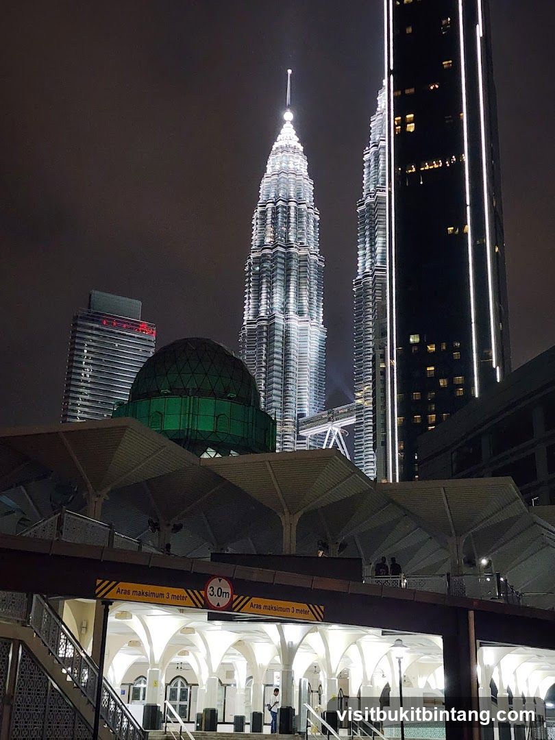 Night view of Petronas Towers and surrounding buildings