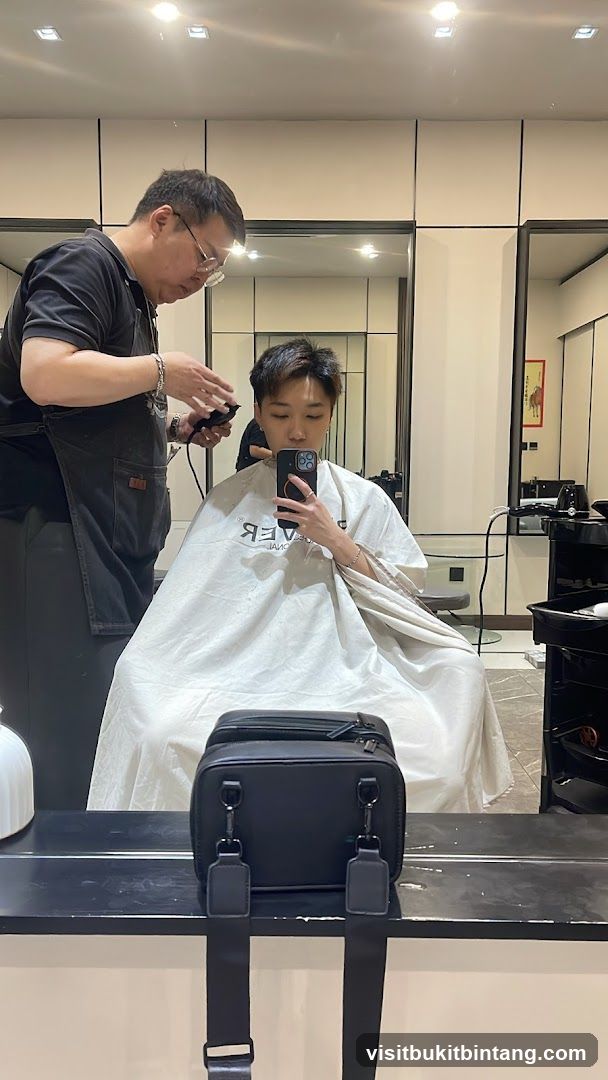 Hairdresser cutting client's hair
