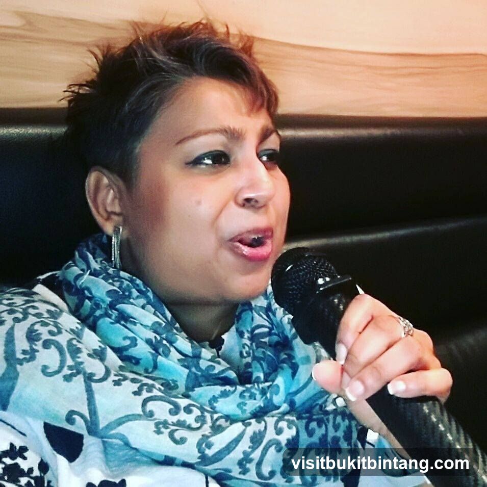 Woman singing into a microphone