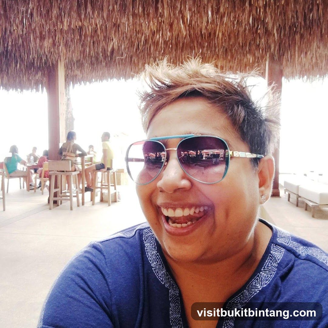 Woman wearing sunglasses at a beachside establishment