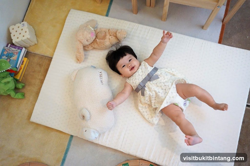 Baby on a playmat with toys