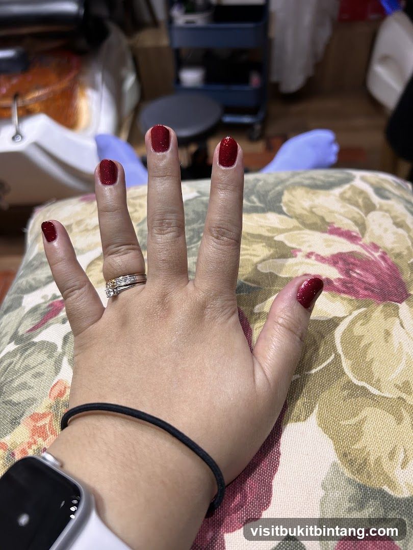 Woman's Hand with Red Glitter Nail Polish