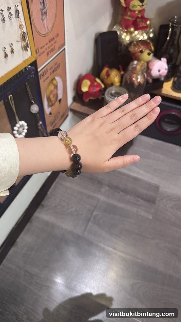 Hand wearing a beaded bracelet