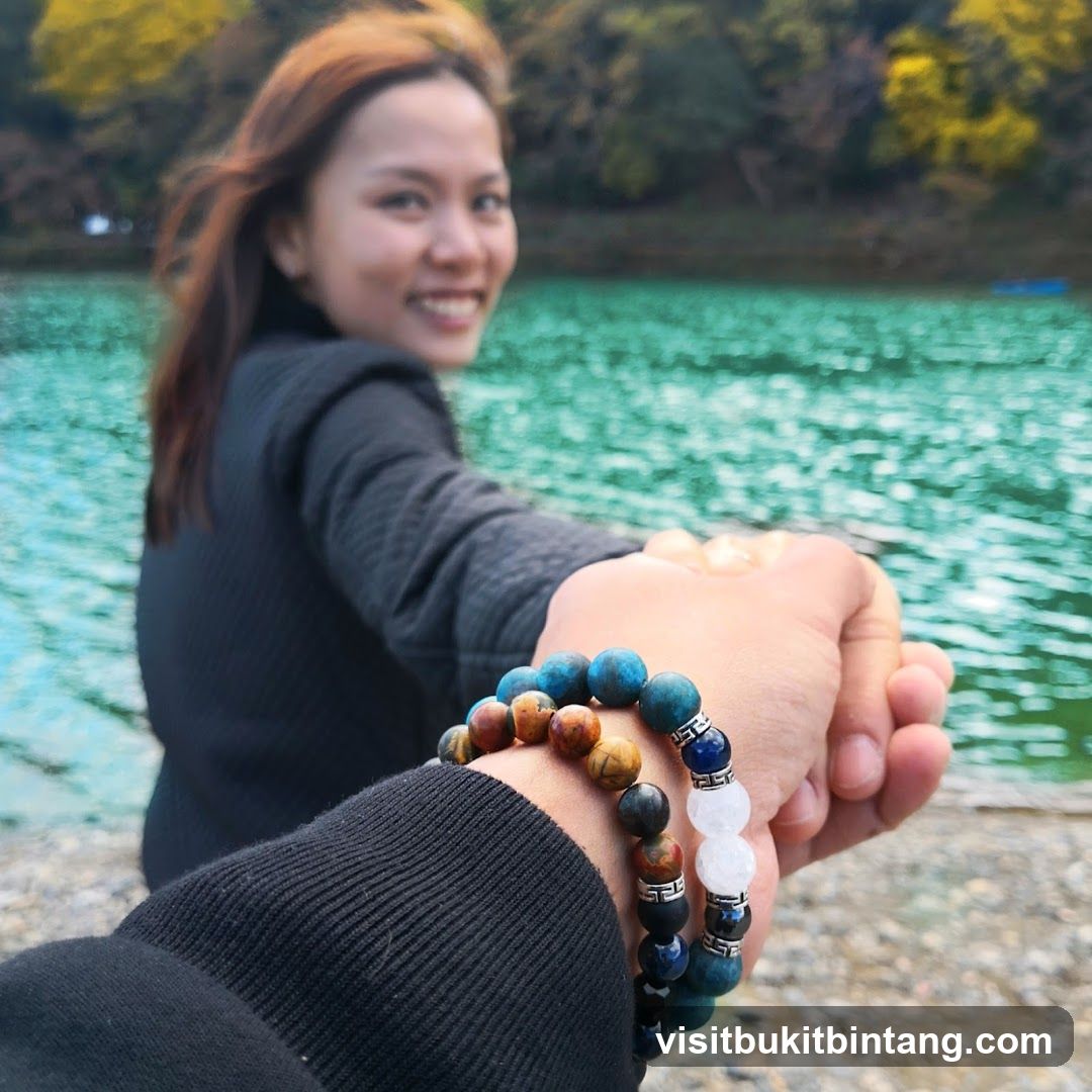 Couple holding hands by the water