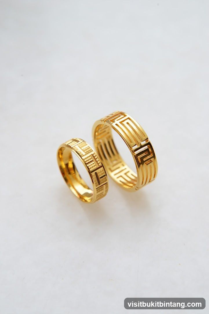 Two gold rings with geometric patterns