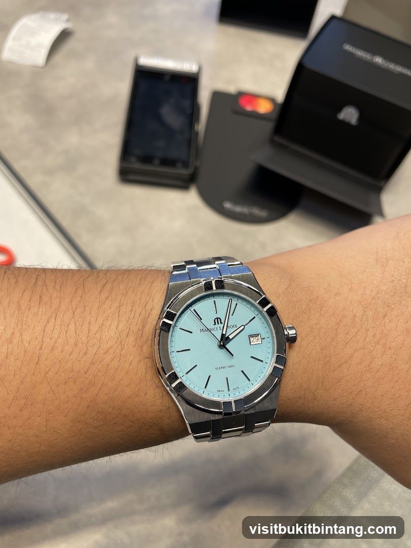 Watch on wrist with payment terminal in background