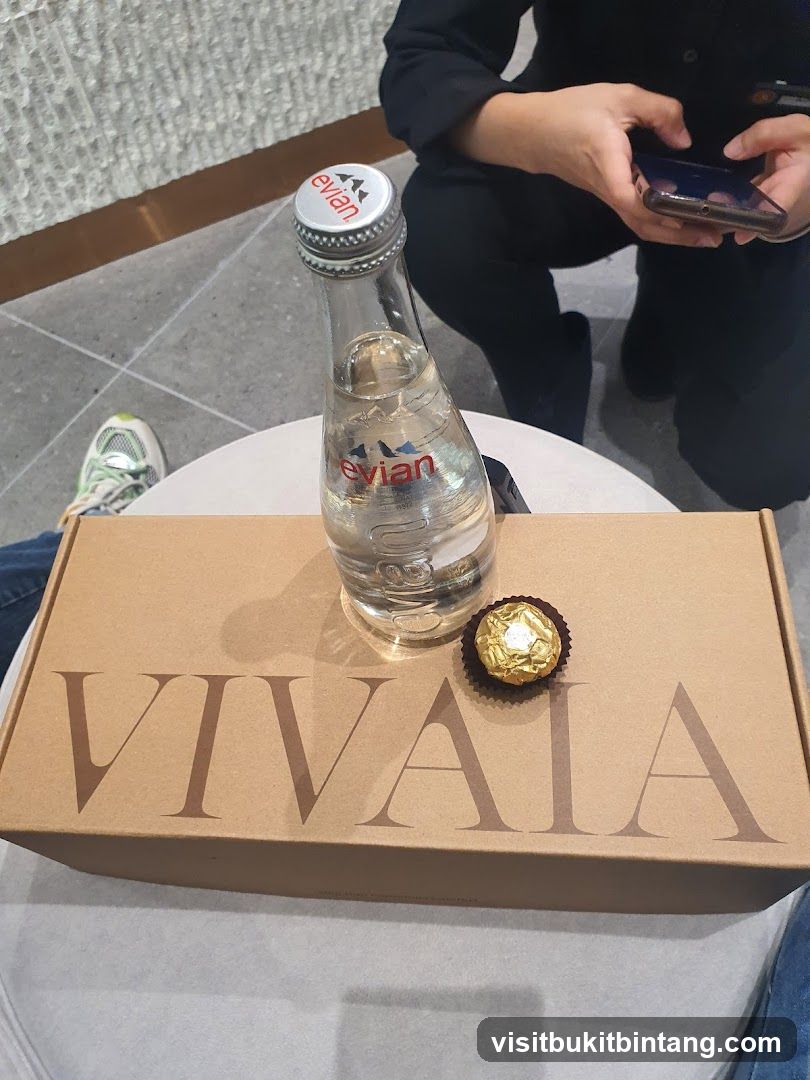 Evian water bottle and Ferrero Rocher chocolate on a box