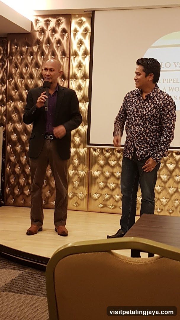 Two men on stage at an event