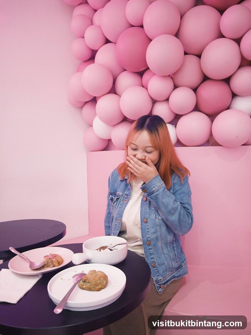 Woman laughing at a table with desserts