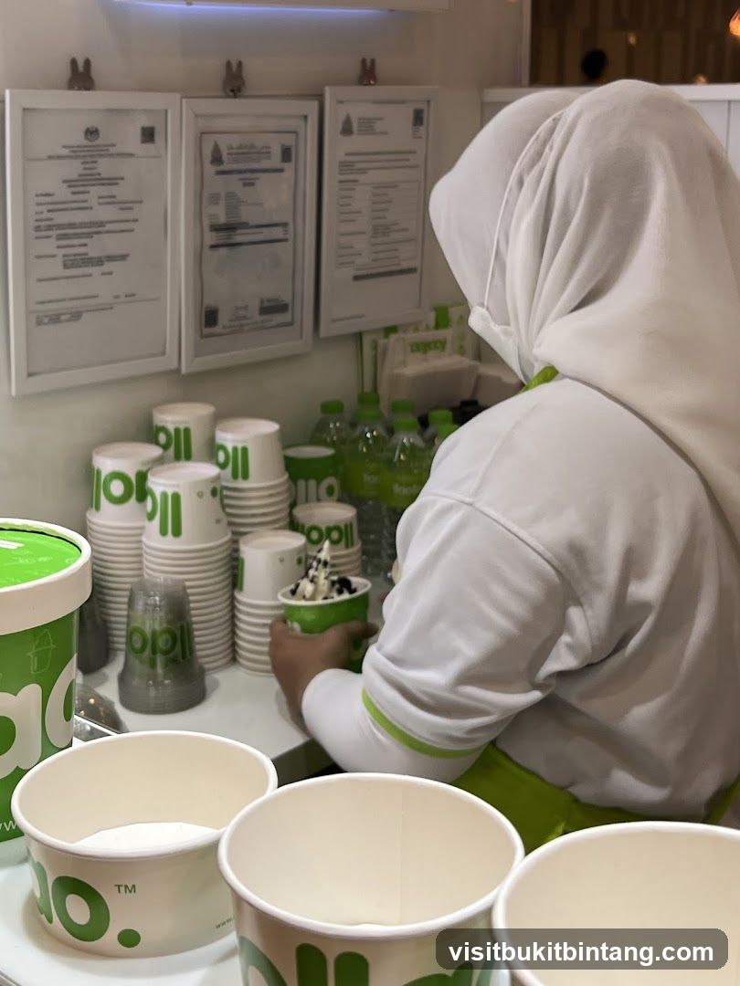 Staff preparing a frozen yogurt order