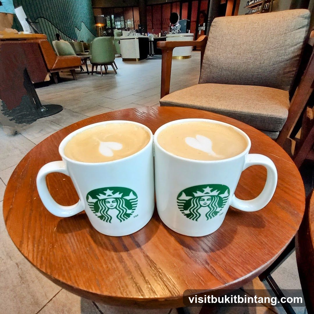 Two lattes with latte art on a table