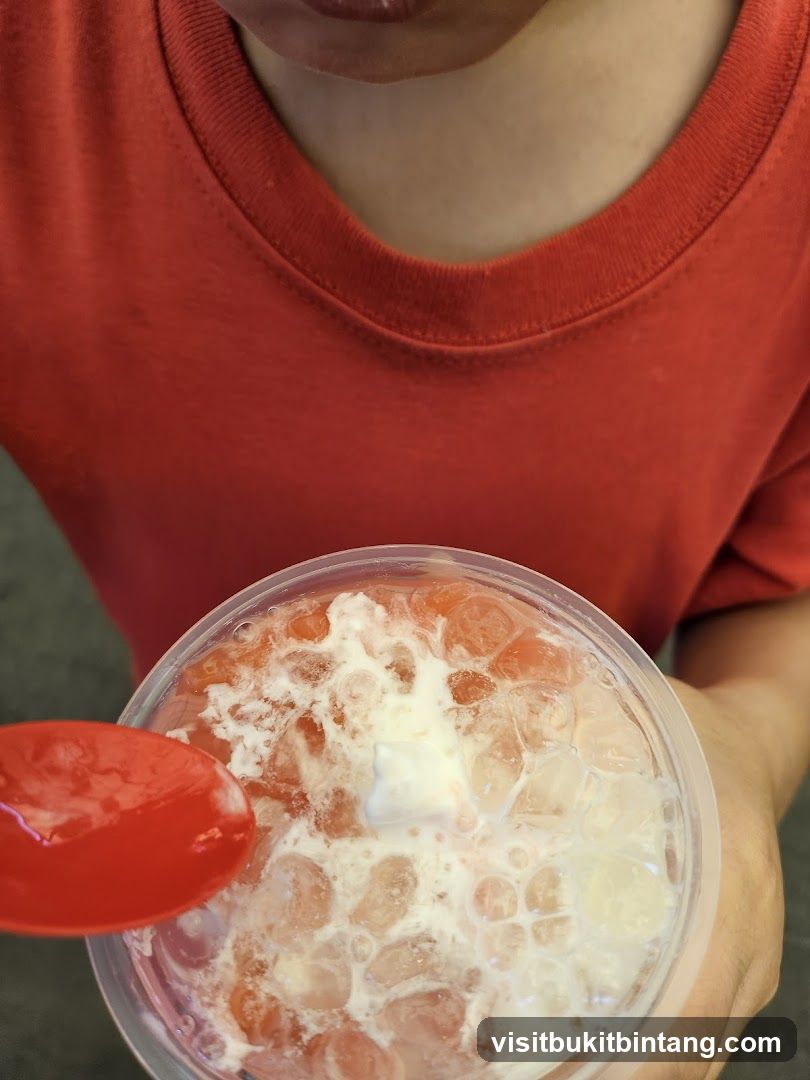 Person holding a drink with a spoon