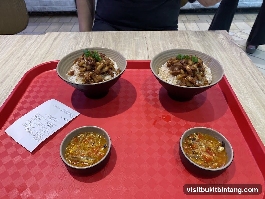 Two bowls of braised pork rice with side dishes