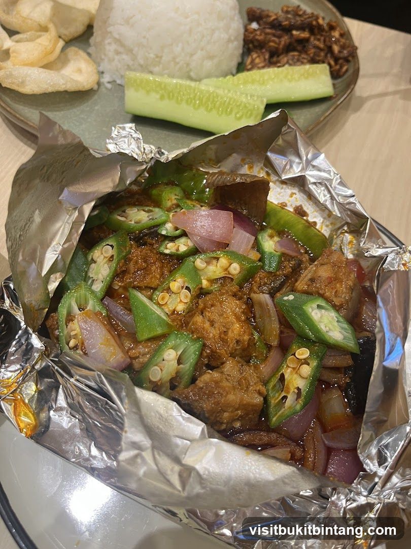 Foil-wrapped dish with rice and sides