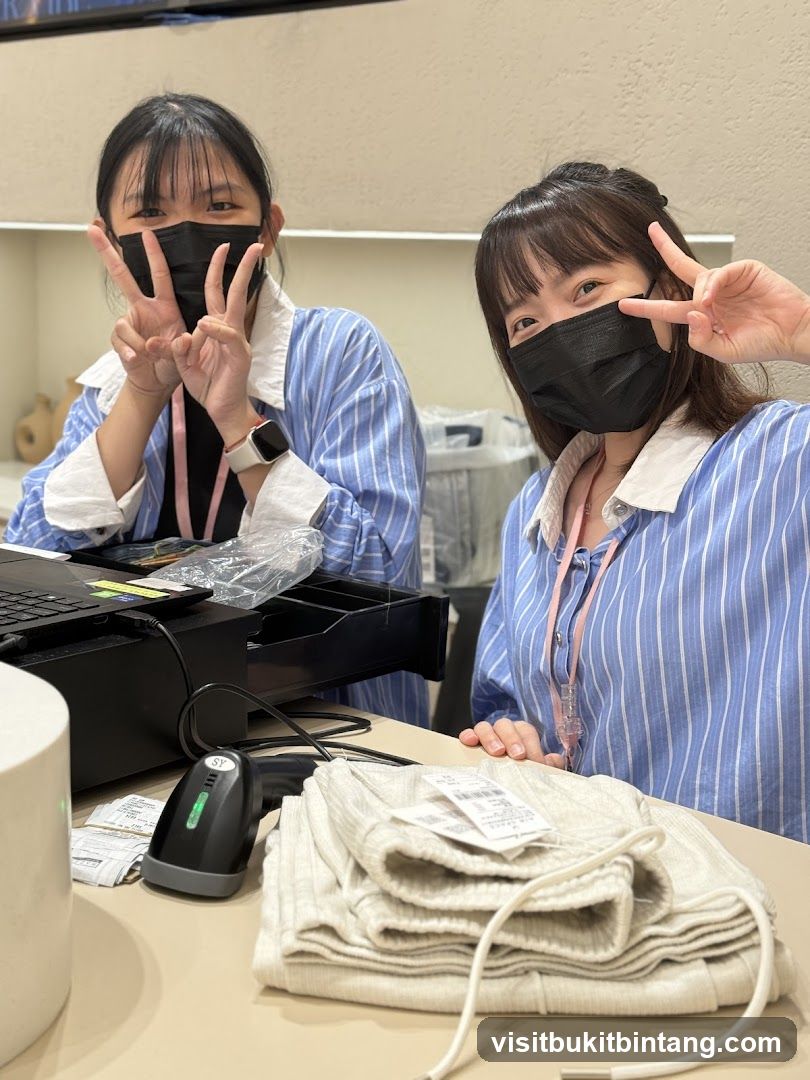 Two masked women at a checkout counter