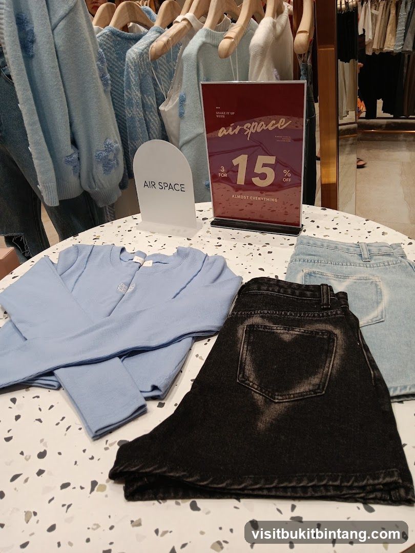 Clothing display with sale sign