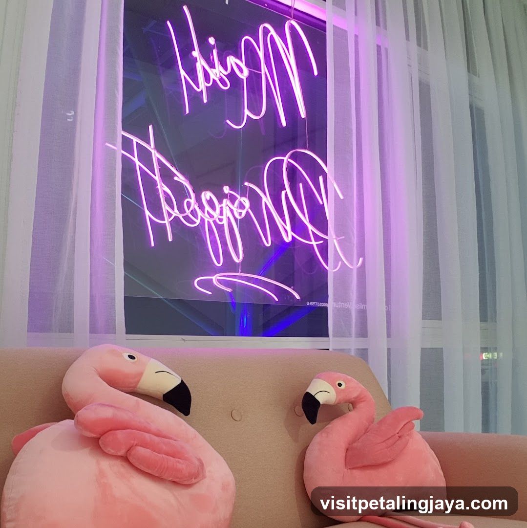 Pink flamingo plushies and neon sign