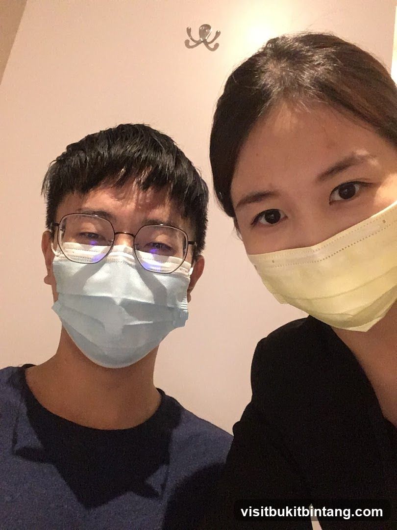 Two people wearing masks