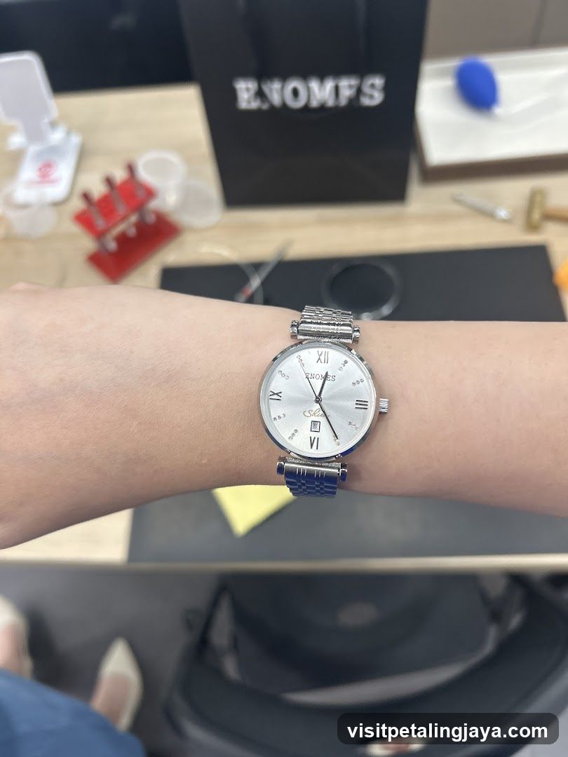 Watch on wrist with ENOMFS bag in background