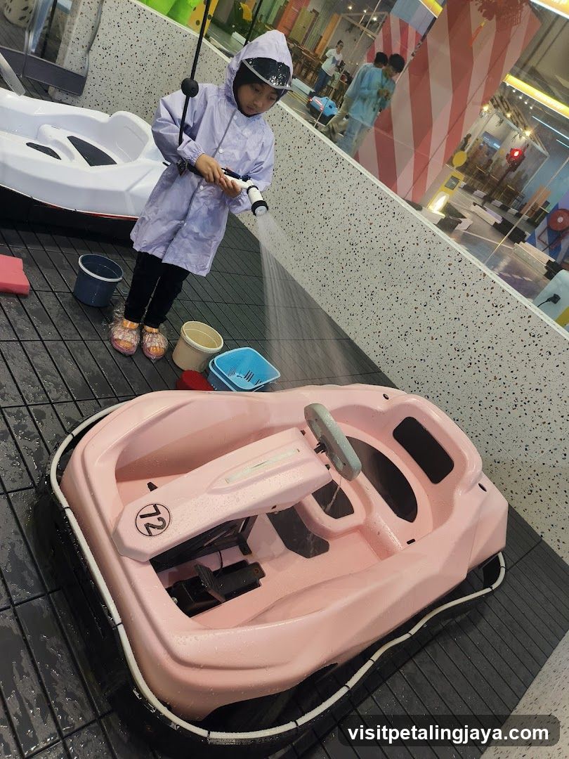 Child Washing a Pink Boat at Indoor Play Area
