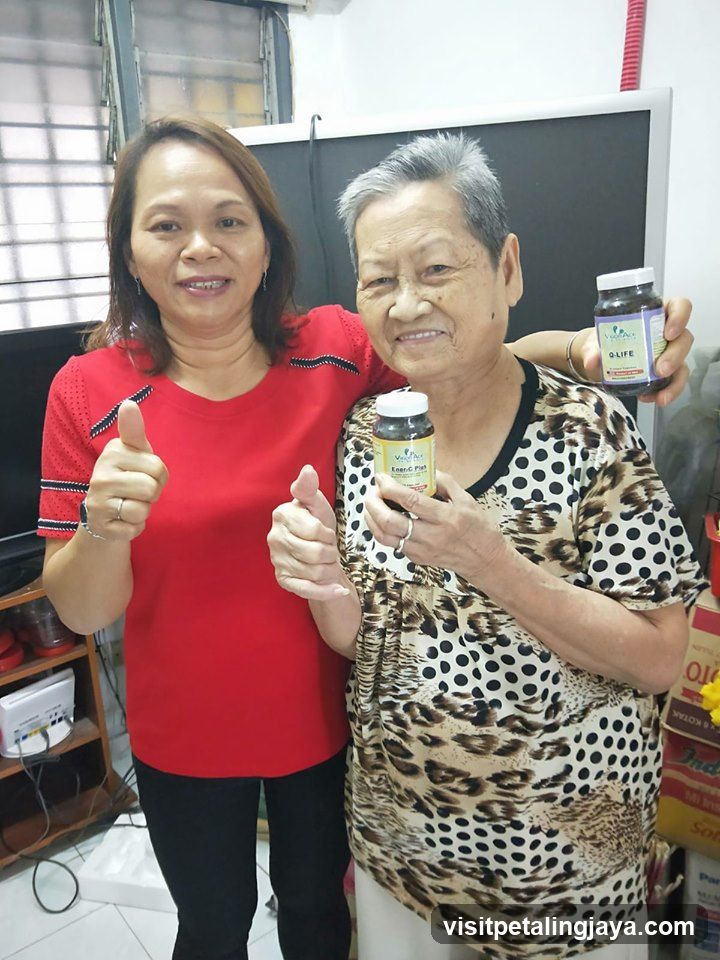 Two women holding supplement bottles