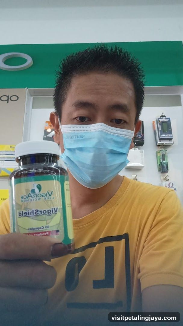 Person holding VigorShield supplement bottle