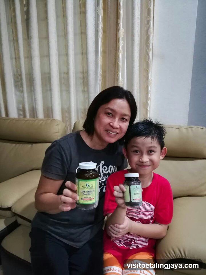 Mother and son holding supplement bottles