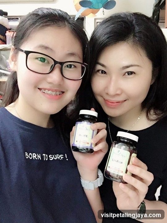 Two women holding supplement bottles