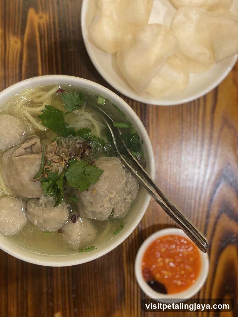 Bowl of Meatball Noodle Soup with Dipping Sauce and Fried Dough