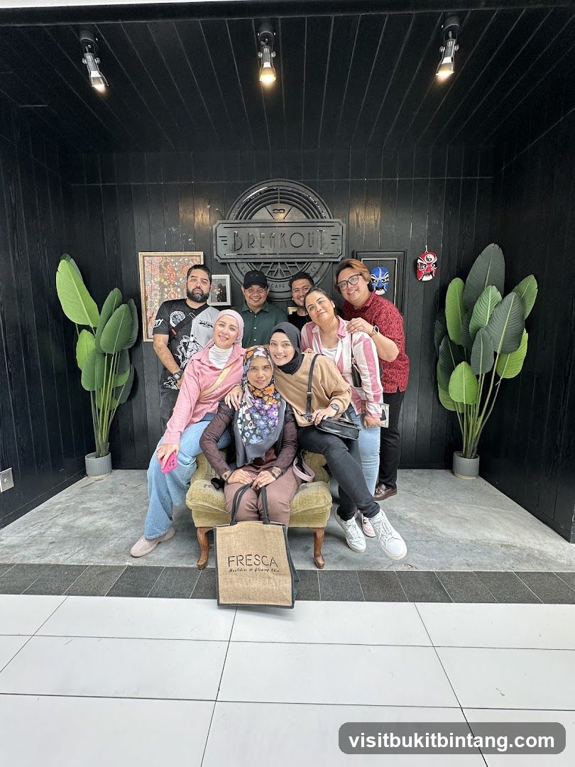 Group posing in front of Breakout signage