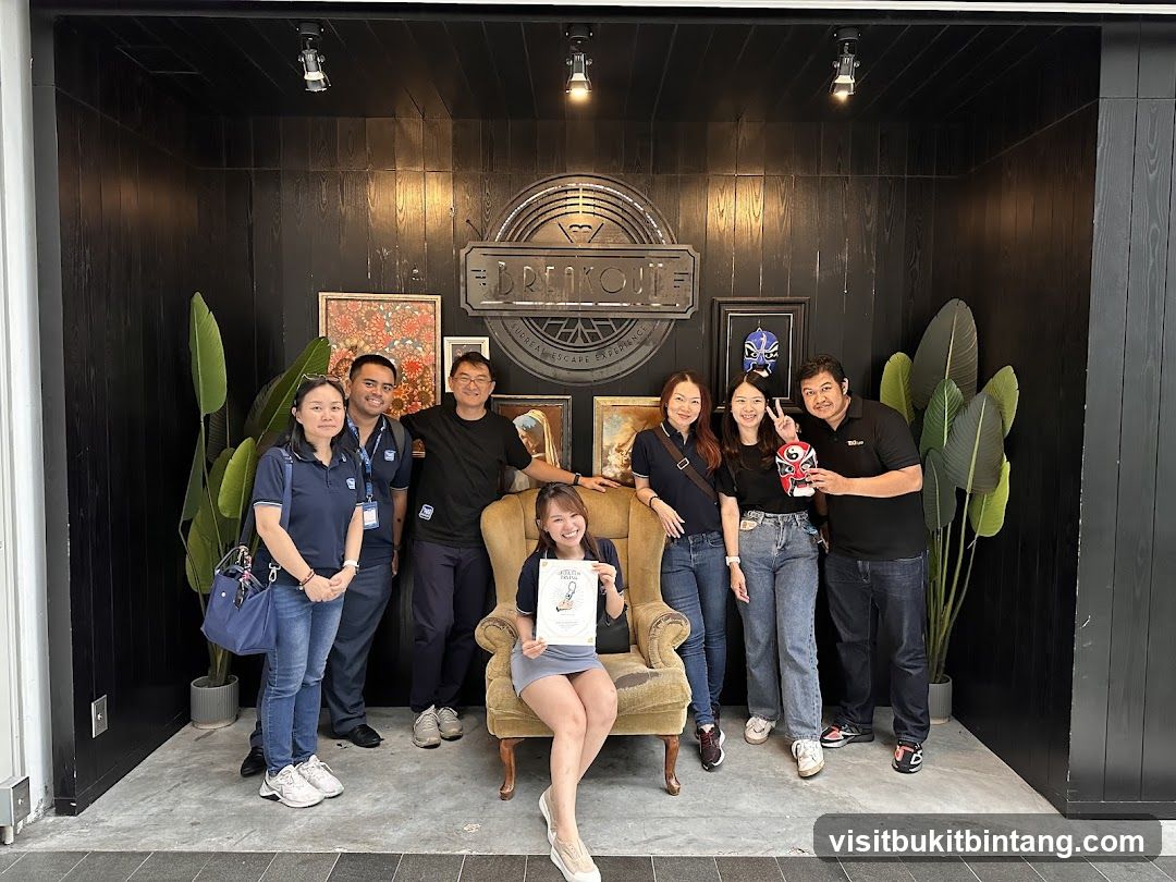 Group Posing in Front of Breakout Signage