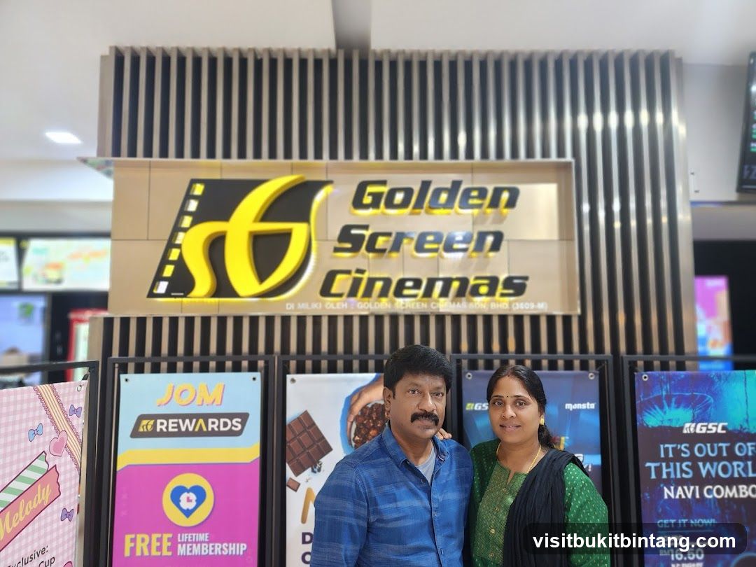 Couple Posing in Front of Golden Screen Cinemas Signage