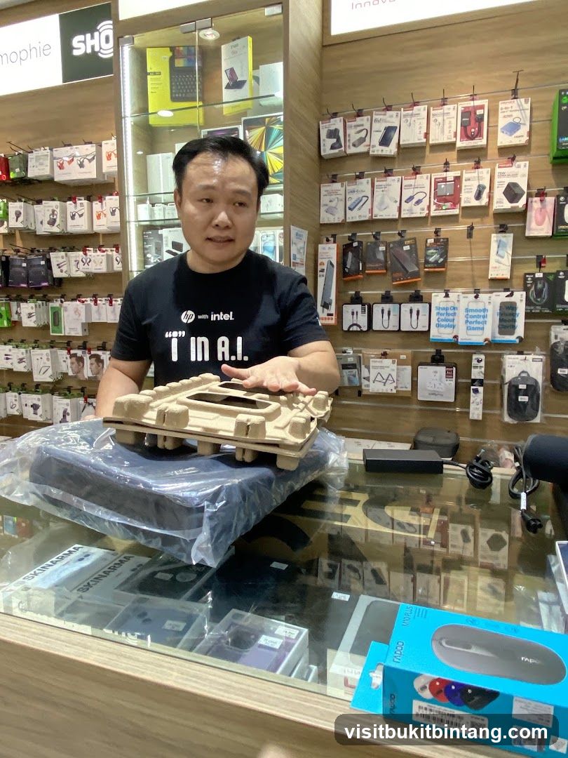 Man holding a laptop in a store