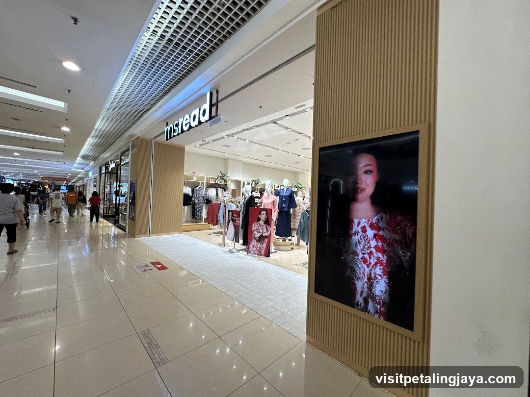 Shopping Mall Corridor with Storefronts and Digital Display
