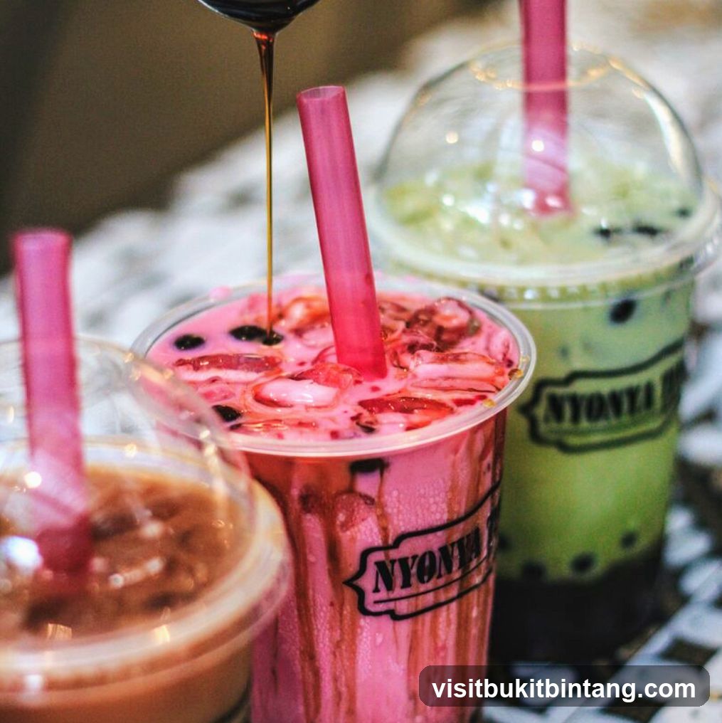 Three colorful drinks with straws
