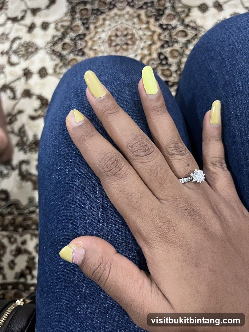 Woman's Hand with Yellow Nails and Ring