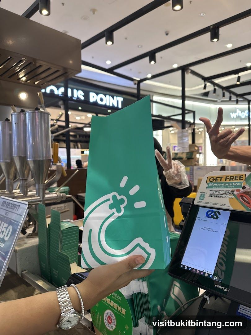 Customer receiving a branded bag at a counter